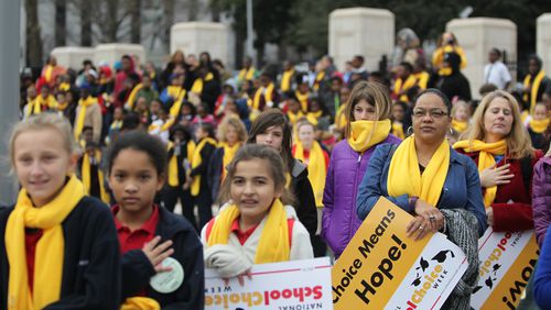 January 25, 2016 Atlanta - The crowd listens to the national anthem at the school choice rally. The rally took place at the state Capitol, and highlighted legislation aimed at expanding charter schools and other school choice options in Georgia.TAYLOR CARPENTER / TAYLOR.CARPENTER@AJC.COM