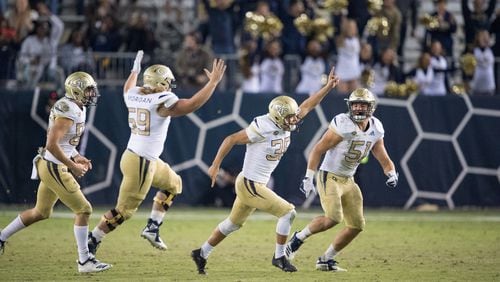 ATLANTA, GA - NOVEMBER 17: Place kicker Wesley Wells #38 of the Georgia Tech Yellow Jackets celebrates with teammates after kicking a field goal during the fourth quarter in their game against the Virginia Cavaliers at Bobby Dodd Stadium on November 17, 2018 in Atlanta, Georgia. (Photo by Michael Chang/Getty Images)