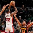 Miami Heat forward Jimmy Butler (22) shoots against Atlanta Hawks forward De'Andre Hunter (12) during the first half of an NBA basketball game, Tuesday, April 9, 2024, in Atlanta. Miami won 117-111 in two overtimes. (AP Photo/Mike Stewart)