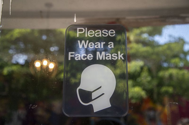 A sign asks customers to wear a mask at the vintage clothing store Drugstore Atlanta in Little Five Points in Atlanta. (Alyssa Pointer/Atlanta Journal Constitution)