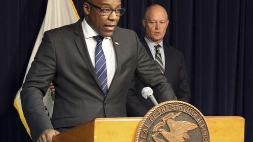 Illinois Attorney General Kwame Raoul (left) speaks at a news conference last month.