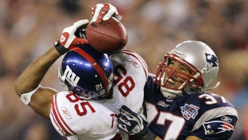 In this Feb. 3, 2008 file photo, New York Giants receiver David Tyree (85) catches a 32-yard pass in the clutches of New England Patriots safety Rodney Harrison (37) during the fourth quarter of the Super Bowl XLII football game at University of Phoenix Stadium in Glendale, Ariz. (AP Photo/Gene Puskar/FILE)