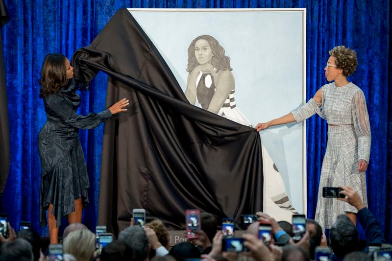 Former first lady Michelle Obama and artist Amy Sherald, right, unveil Michelle Obama's official portrait at the Smithsonian's National Portrait Gallery in 2018. (AP Photo/Andrew Harnik)