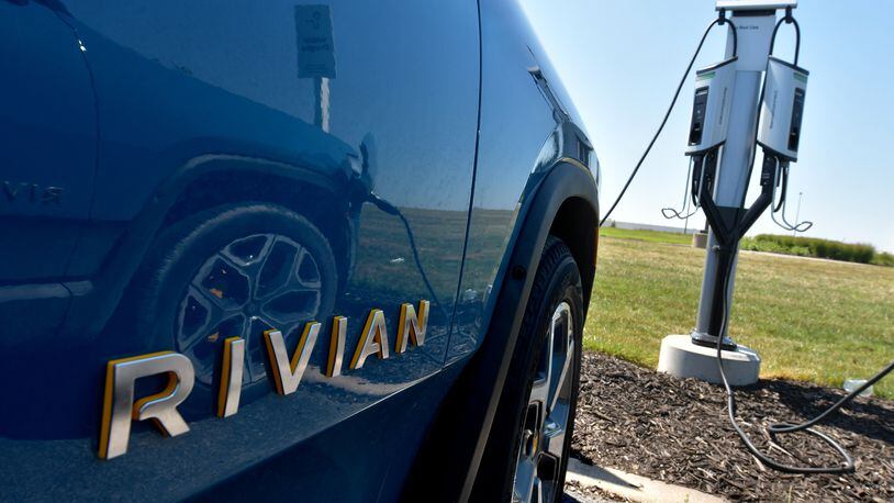 The Rivian R1T electric vehicle is connected to a charging station outside the Rivian Plant in Normal, Ill., on July 20, 2022. (Photo for the Atlanta Journal Constitution by Ron Johnson)