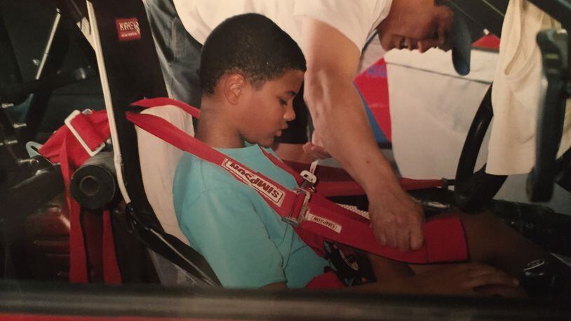 A young Eason Fromayan tests out a race-car cockpit. (Courtesy Fromayan family)