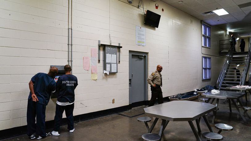 Inmates are seen using a kiosk in their cell block that allows them to schedule visits and medical appointments during a tour of the Fulton County Jail on Monday, Dec. 9, 2019, in Atlanta. (Elijah Nouvelage/Special to the Atlanta Journal-Constitution)