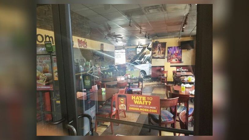 A nine-vehicle wreck ended with a van crashing through a Moe's restaurant in North Georgia. (Credit: Channel 2 Action News)
