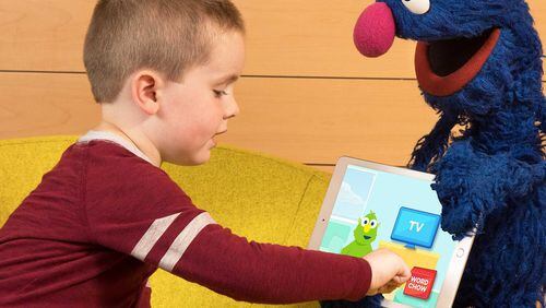 A child plays on a tablet as the Sesame Street character Grover watches. The Sesame Workshop and IBM have partnered to create an app that will improve the vocabulary of kindergarten students nationwide. The companies recently tested the app with about 150 Gwinnett County students. PHOTO CONTRIBUTED.