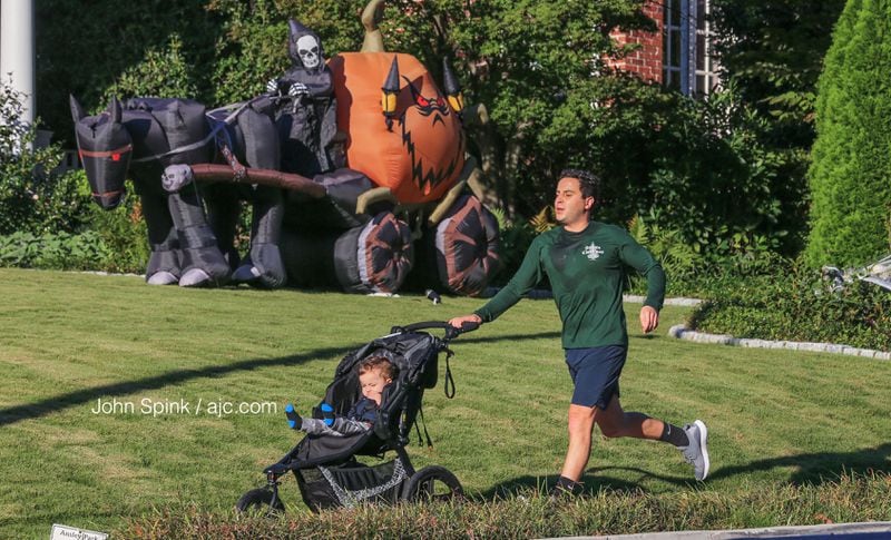 David Abraham jogs with 1-year-old Ramsey in Midtown as the temps dipped Thursday morning.