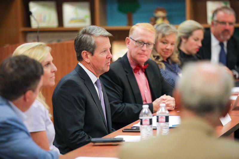 Gov. Brian Kemp meets with education officials at Ball Ground Elementary School on Aug. 6. The event was one of several in recent weeks that the governor attended indoors without a mask. Kemp shared this image on one of his Twitter feeds. 