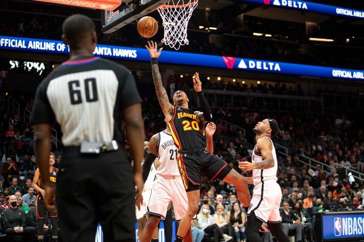 The Hawks' John Collins (20) shoots the ball during a game between the Atlanta Hawks and the Brooklyn Nets at State Farm Arena in Atlanta, GA., on Friday, December 10, 2021. (Photo/ Jenn Finch)