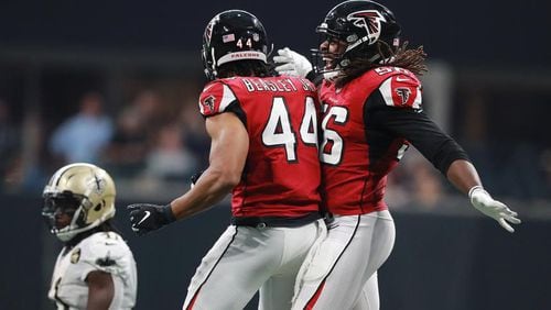 Vic Beasley Jr. of the Falcons celebrates his sack of Saints quarterback Drew Brees with Steven Means on Sunday, Sept 23, 2018, in Atlanta. Curtis Compton/ccompton@ajc.com