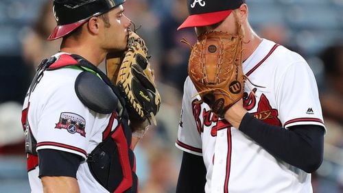 Braves catcher Anthony Recker (left) chats with pitcher Mike Foltynewicz. Recker signed a one-year, $800,000 contract Friday, avoiding arbitration. (Curtis Compton /ccompton@ajc.com)