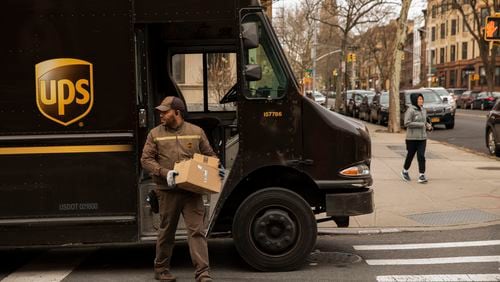 FILE -- A UPS driver makes the rounds in Brooklyn's Park Slope neighborhood, March 18, 2020. UPS announced in November that it will allow workers to have facial hair and natural Black hairstyles like Afros and braids,  becomes the latest company to shed policies widely criticized as discriminatory. (Benjamin Norman/The New York Times)