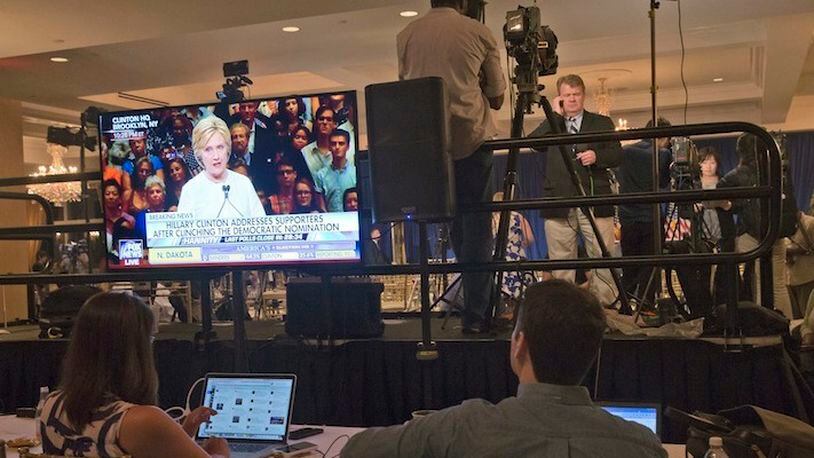 Democratic presidential candidate Hillary Clinton is seen on a television screen addressing her supporters as reporters file their stories after a news conference by Republican presidential candidate Donald Trump at the Trump National Golf Club Westchester, Tuesday, June 7, 2016, in Briarcliff Manor, N.Y. ( Photo/Mary Altaffer)
