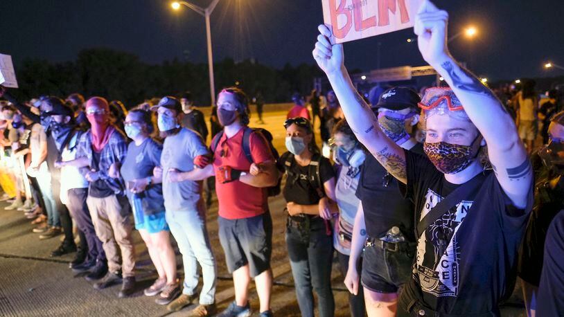 Demonstrators get on to I-75 and shut down the interstate Saturday night.  Throughout the day, protesters gathered at the Wendy's where Rayshard Brooks, a 27-year-old black man,  was shot and killed by Atlanta police the night before.    Ben Gray for the Atlanta Journal Constitution