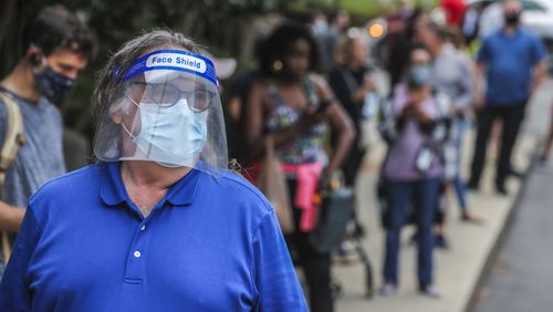 June 9, 2020 Atlanta:  Tom Mroz waits to vote is face shield and mask at the Park Tavern polling place located at 500 10th St NE, in Atlanta on Tuesday, June 9, 2020. Many voters said they requested absentee ballots but never received them. Two lines, 300-yards long each formed parallel to Piedmont park in the parking lot as people patiently waited to vote. Over 1.2 million people had already voted before the polls opened on Tuesday, three-quarters of them with absentee-by-mail ballots, allowing them to avoid human contact at the polls. Voters will decide on many candidates, from president to county sheriff. The ballot also includes races for U.S. Senate, U.S. House and the Georgia General Assembly. JOHN SPINK/JSPINK@AJC.COM