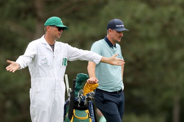 April 9, 2021, Augusta: Justin Rose and his caddie David Clark discuss RoseÕs next shot on the fifteenth fairway during the second round of the Masters at Augusta National Golf Club on Friday, April 9, 2021, in Augusta. Curtis Compton/ccompton@ajc.com