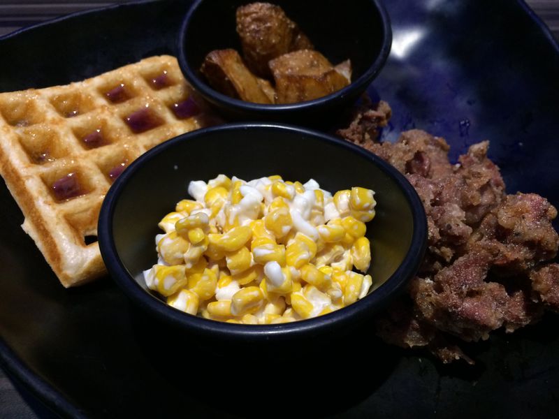 Every Thank U Chicken platter comes with these sides: a maple syrup-soaked waffle; cheese and corn; chopped fried chicken gizzards and fried potatoes. CONTRIBUTED BY WENDELL BROCK