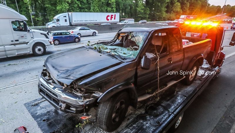 A pickup truck was hit by a tree as it fell across the southbound lanes of I-285 in DeKalb County on Thursday morning. The driver appears to be OK, according to police. 