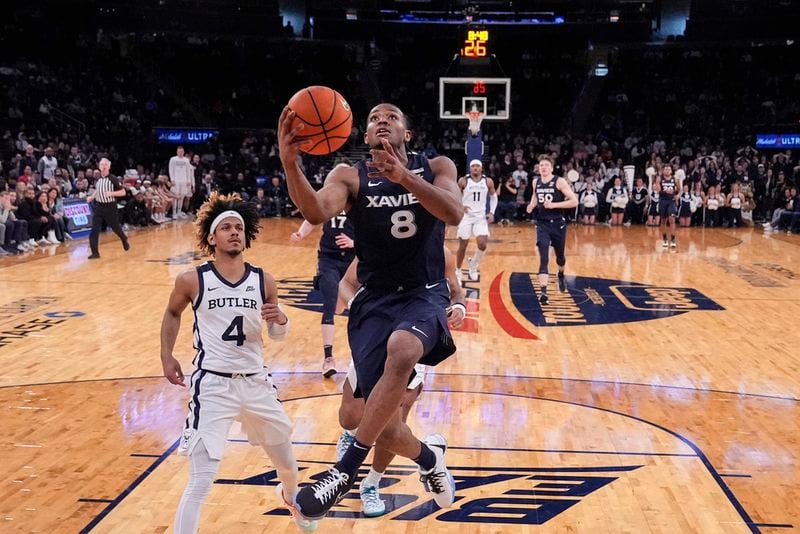Xavier's Quincy Olivari (8) drives past Butler's DJ Davis (4) during the second half of an NCAA college basketball game in the first round of the Big East Conference men's tournament Wednesday, March 13, 2024, in New York.nam (AP Photo/Frank Franklin II)
