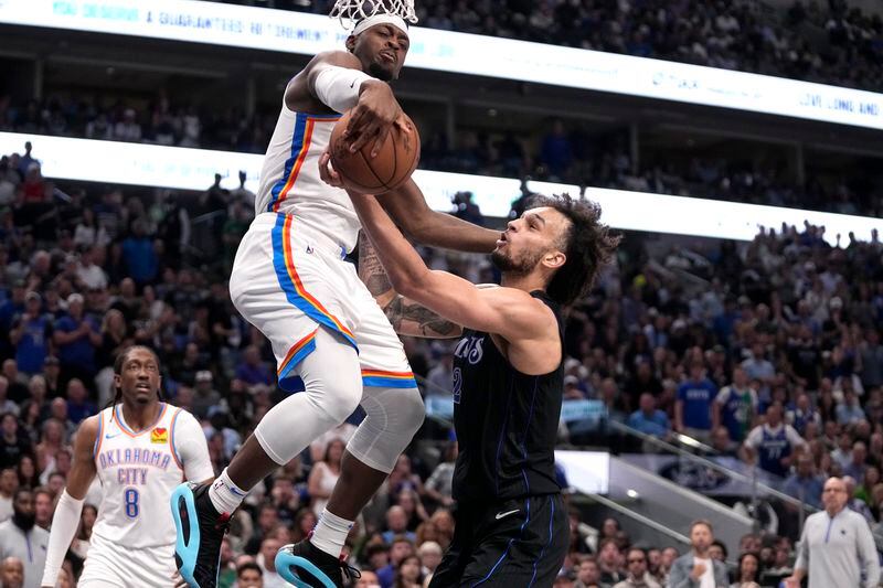 Oklahoma City Thunder guard Luguentz Dort (5) blocks a shot by Dallas Mavericks' Dereck Lively II, right, in the second half of Game 6 of an NBA basketball second-round playoff series Saturday, May 18, 2024, in Dallas. (AP Photo/Tony Gutierrez)