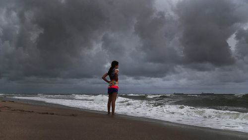 Alicia Herrera, 10, visiting from Germany doesn’t let dark clouds ruin her day at beach Friday, May 25, 2018 in Fort Lauderdale, Fla. A flood watch is expected for South Florida on Saturday morning as a result of Subtropical Storm Alberto. (Carline Jean/Sun Sentinel/TNS)