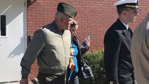 In this Tuesday, Oct., 31, 2017 photo, U.S. Marine Gunnery Sgt. Joseph A. Felix, his wife, and his lawyers exit a courtroom after testimony at Camp Lejeune, N.C. Military prosecutors say the former Marine Corps drill instructor facing court-martial on charges including cruelty and maltreatment was "drunk on power" and targeted three Muslim recruits for abuse. Testimony began Tuesday, at the military trial of Felix. Prosecutors said Felix punched, choked and kicked recruits at the Marine Corps' Parris Island, South Carolina, training center. (Rory Laverty /The Washington Post/via AP)