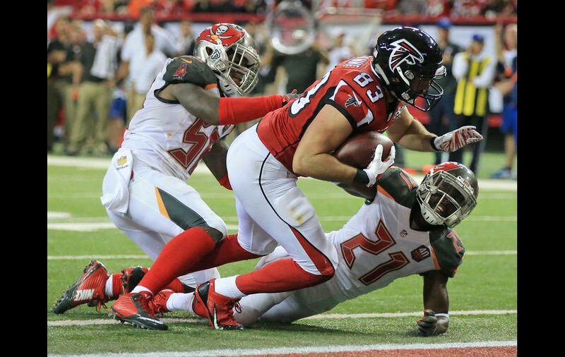 Falcons tight end Jacob Tamme knocks Buccaneers cornerback Alterraun Verner to the ground on his way into the endzone for a touchdown to cut the Buccaneers lead to 20-10 during the third quarter in a football game on Sunday, Nov. 1, 2015, in Atlanta. The Falcons fall 23-20 to the Buccaneers in over time. (Photo by Curtis Compton)