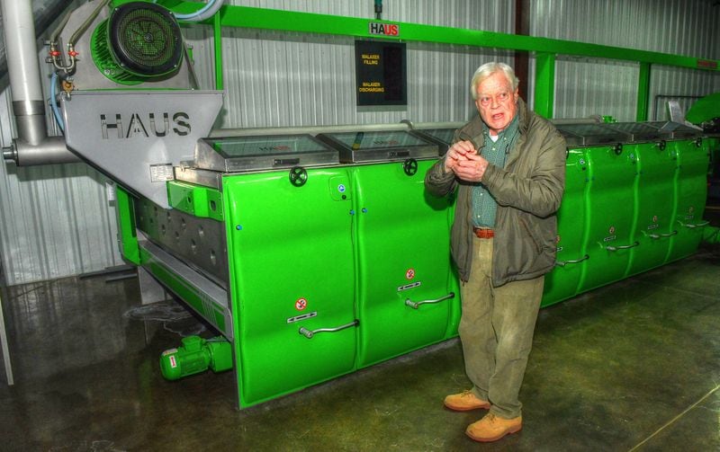 Standing by the malaxer, which grinds olives into a mash so the oil can be extracted, Cooley Hobdy explains the milling and bottling process at his facilities. 
Contributed by Chris Hunt for The Atlanta Journal-Constitution)