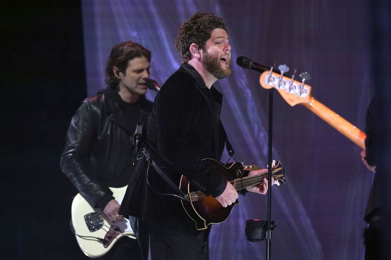 Tyler Burkum, left, and Josh Lovelace of Needtobreathe perform "I Wanna Remember" with Carrie Underwood at the CMT Music Awards on Wednesday, May 5, 2021, in Nashville. (AP Photo/Mark Humphrey)