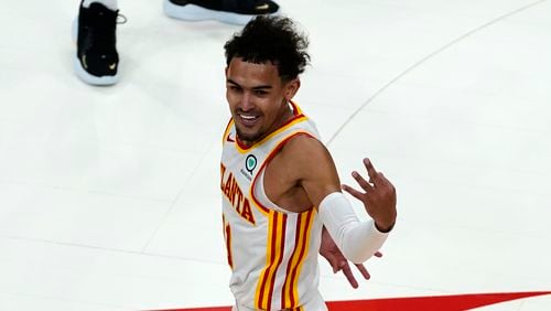 Atlanta Hawks guard Trae Young (11) reacts after an Atlanta basket in the second half of an NBA basketball game against the New Orleans Pelicans Tuesday, April 6, 2021, in Atlanta. (AP Photo/John Bazemore)