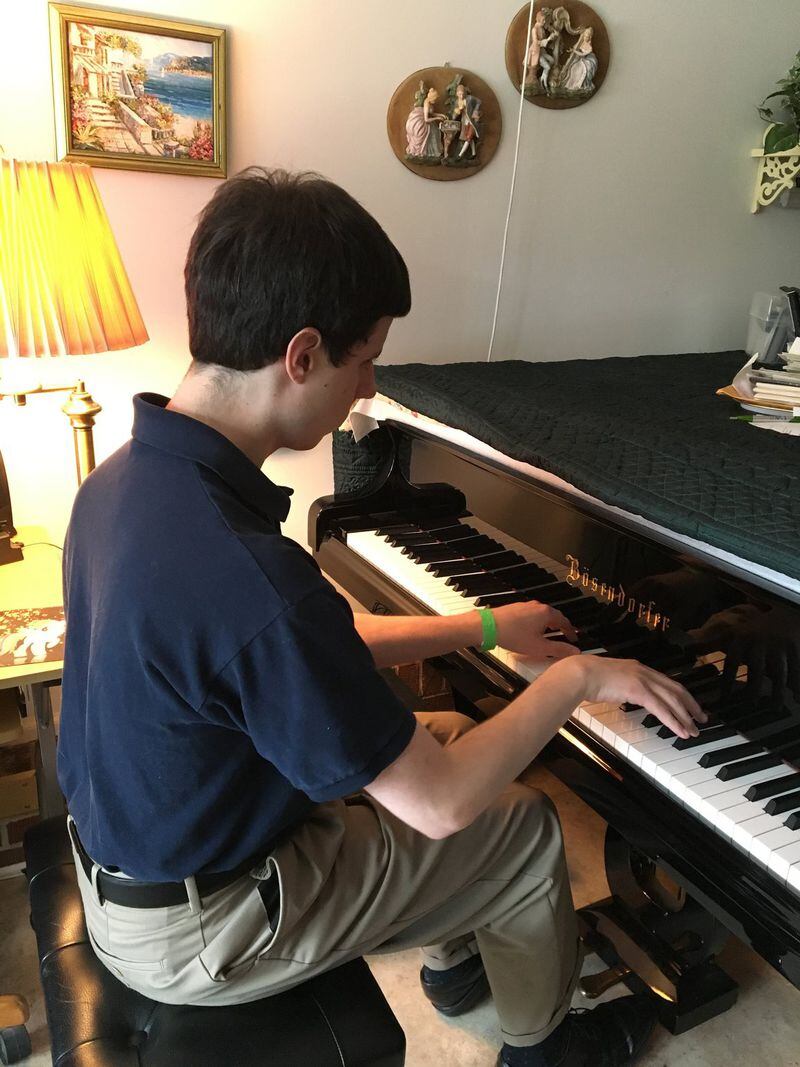 Timothy Jones performs Debussy’s Clair de Lune at his Norcross home on a recent afternoon. Contributed by Frank Reddy