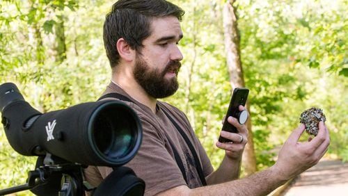 Adam Betuel of the Atlanta Audubon Society talks about a blue-gray gnatcatcher nest found during his birding walk at Constitution Lakes Park. During his walk Betuel broadcast his discoveries to birding enthusiasts by way of a Facebook Live streaming presentation. (Jenni Girtman for Atlanta Journal Constitution)