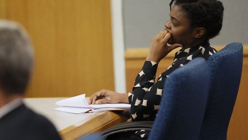 Tiffany Moss listens to testimony during her murder trial for starving to death her 10-year-old stepdaughter in 2013. Bob Andres / bandres@ajc.com