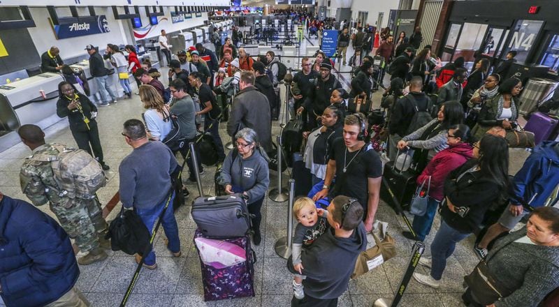 The ticket counters were swamped with travelers in the North terminal on Monday after a massive power outage brought operations to halt on Sunday. JOHN SPINK/JSPINK@AJC.COM