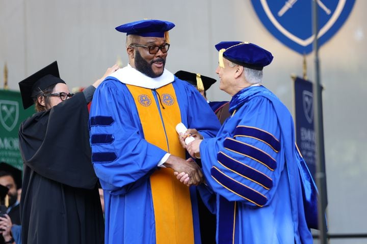 Georgia-based producer and director Tyler Perry get congratulated by Emory’s president, Gregory L. Fenves, after receiving the honorary doctor in letters during Emory University’s 2022 Commencement  on Monday, May 9, 2022.  Miguel Martinez /miguel.martinezjimenez@ajc.com