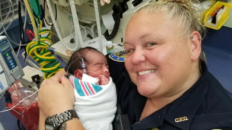 Chamblee police officer Beth Frye with the newborn boy found in a gym bag in Chamblee. The baby is doing OK.