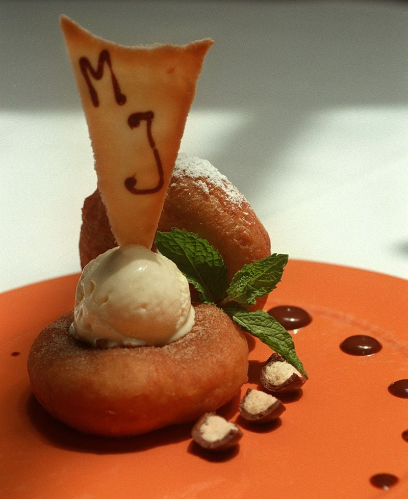 Doughnuts with malt ball ice cream, almonds and chocolate. / AJC file photo