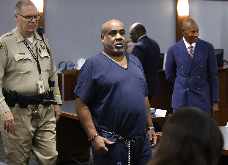 Duane “Keffe D” Davis, who is accused of orchestrating the 1996 slaying of hip-hop icon Tupac Shakur, center, and his attorney Carl Arnold, right, appear in court during a status hearing at the Regional Justice Center, on Tuesday, April 23, 2024, in Las Vegas. (Bizuayehu Tesfaye/Las Vegas Review-Journal via AP)