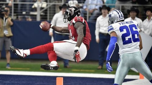 Atlanta Falcons wide receiver Julio Jones (11) sails into the end zone for a touchdown as Dallas Cowboys defensive back Tyler Patmon (26) watches in the second half of an NFL football game in Arlington, Texas. (AP Photo/Michael Ainsworth)