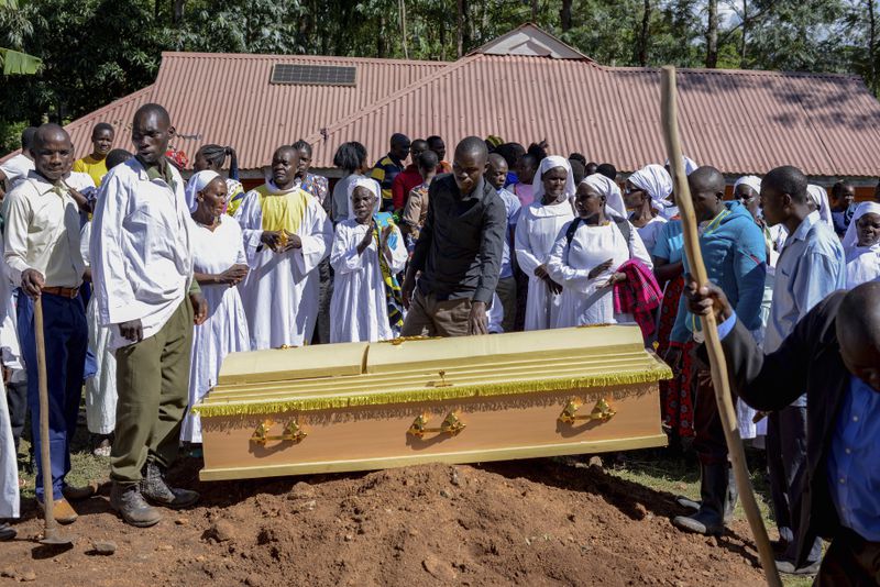Friends and family prepare to lower the casket of Rose Bella Awuor, 31 years, after a funeral service at her home in Awendo, Migori County, Kenya Thursday, April. 11, 2024. Awuor fell ill in December and lost her five-month pregnancy before succumbing to malaria. It was the latest of five deaths in this family attributed to malaria. The disease is endemic to Kenya and is preventable and curable, but poverty makes it deadly for those who can't afford treatment. (AP Photo/Brian Ongoro)