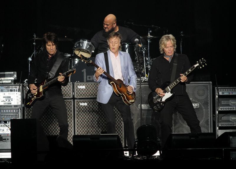  McCartney, flanked by guitarists Rusty Anderson (left) and Brian Ray, with drummer Abe Laboriel Jr. behind him. (Akili-Casundria Ramsess/Eye of Ramsess Media)