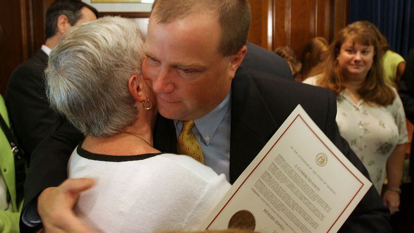 ATLANTA, GA -- Former Olympic security guard Richard Jewell hugs his mother Barbara as his wife Dana , at right, looks on Tuesday afternoon, August 1, 2006 after he received a commendation from Gov. Sonny Perdue for his service during the Olympics. (BEN GRAY/AJC staff)