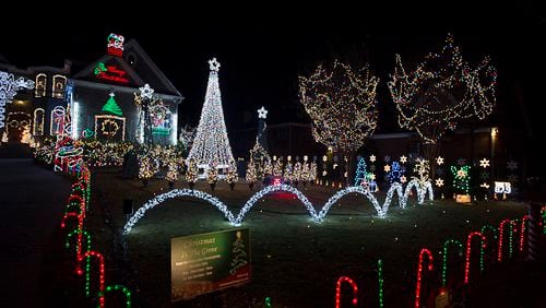 In a file photo, Tony Paradowski shows off his "Christmas in the Grove" lights display at 1428 Oak Grove Drive in Decatur. His family solicits donations to the ALS Association of Georgia, with all proceeds going to the organization.