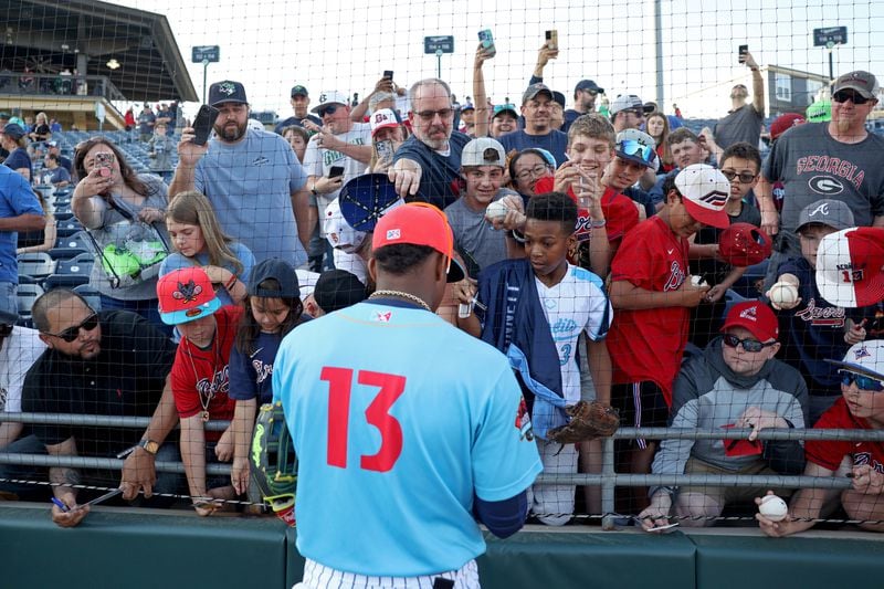 Braves outfielder Ronald Acuna, who’s rehabbing with Triple-A Gwinnett, signs autographs before the Gwinnett Stripers’ game against the Norfolk Tides at Coolray Field Wednesday, April 27, 2022, in Lawrenceville, Ga. (Jason Getz / Jason.Getz@ajc.com)