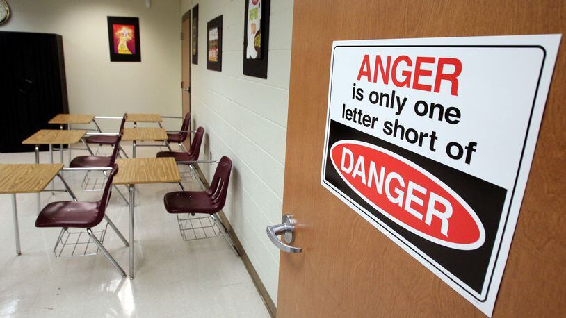 A sign reads “Anger is the only one letter short of Danger,” in the room where students wait to be either returned to school or have a parent pick them up at the Atlanta Public Schools Truancy Office, in this photo taken in 2011. ACJ FILE