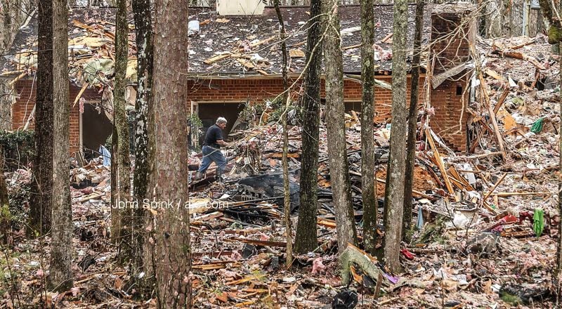 Investigators sift through the rubble of a home destroyed when a propane tank exploded. The home's only resident was killed. JOHN SPINK / JSPINK@AJC.COM