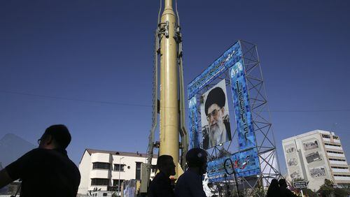 A Ghadr-F missile is displayed next to a portrait of Iranian Supreme Leader Ayatollah Ali Khamenei at a Revolutionary Guard hardware exhibition marking the 36th anniversary of outset of Iran-Iraq war, at Baharestan Sq. in downtown Tehran, Iran, Sunday, Sept. 25, 2016. Iran annually celebrates “Sacred Defense Week” marking the anniversary of the start of 1980-88 war that left about a million casualties on both sides. The Persian writing in banner at right reads, “We stand up to the end.” (AP Photo/Vahid Salemi)