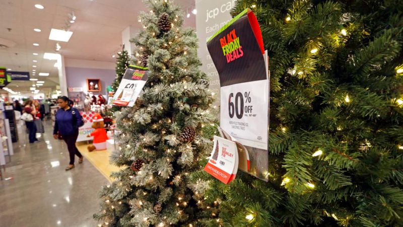 A shopper walks past a display of artificial Christmas trees at a JCPenney store Friday, Nov. 24, 2017, in Seattle. (AP Photo/Elaine Thompson)